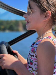 little girl enjoying family time by the lake