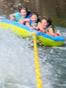 kids tubing on the lake