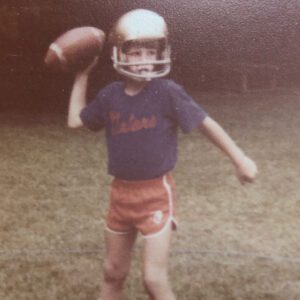 Boy playing sports with football